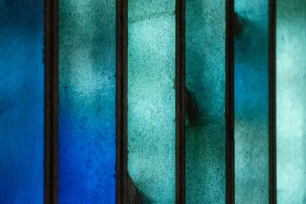 Artisan installing a custom stained glass panel in a residential window