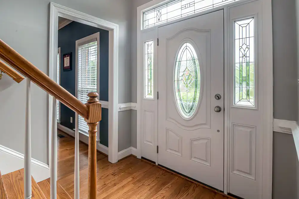 A horizontal stained glass transom window above an interior door