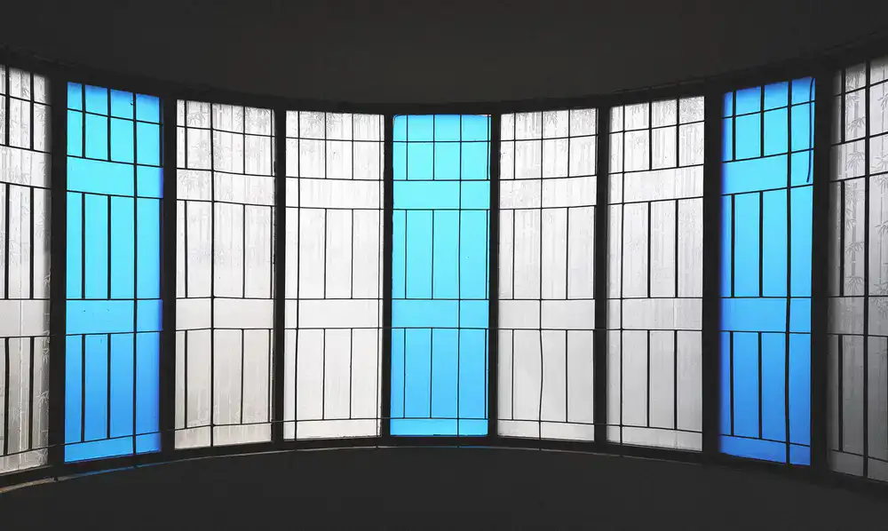 Large architectural stained glass window installed in a domestic setting