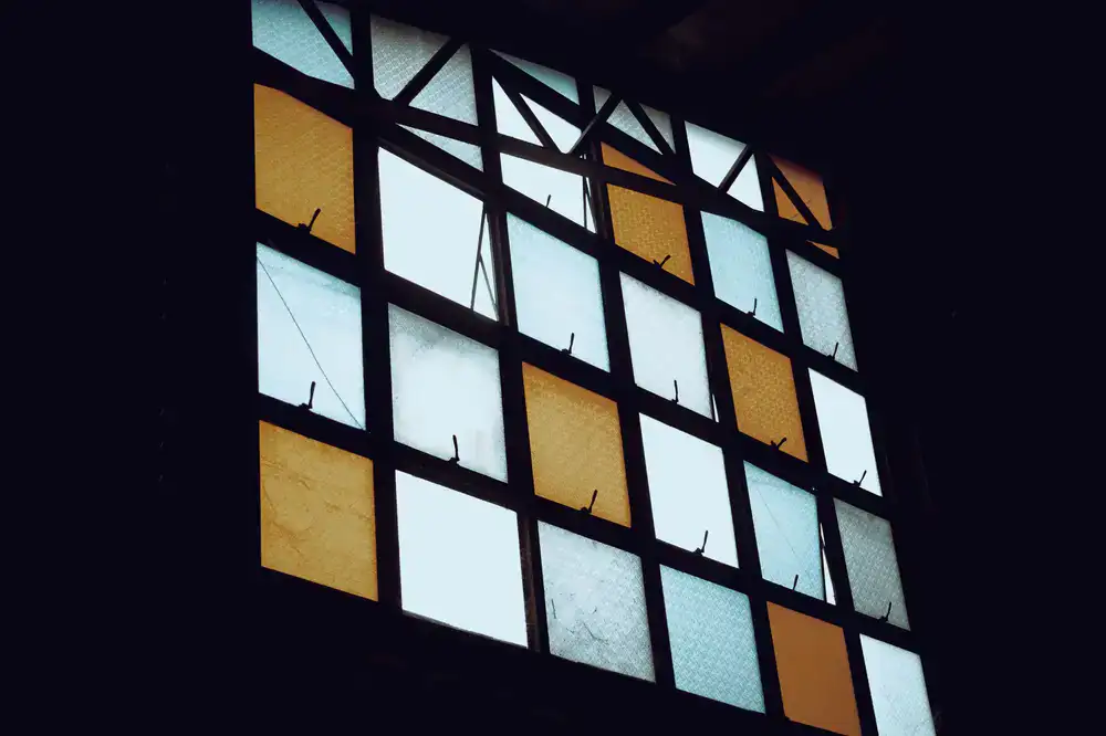 Detailed view of a glowing stained glass panel highlighting the lead lines